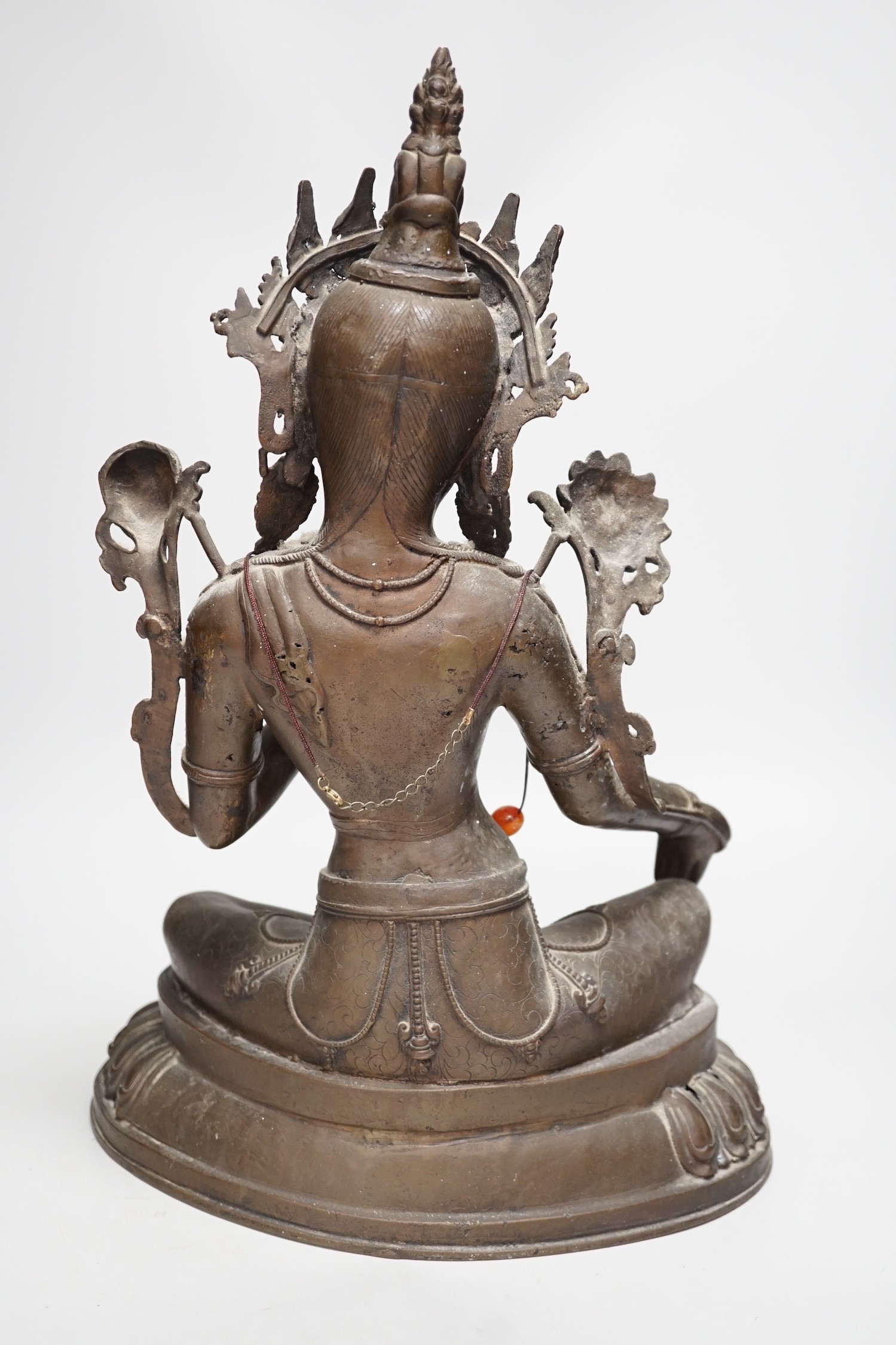 A Buddhist bronze seated figure of Green Tara. 42cm tall